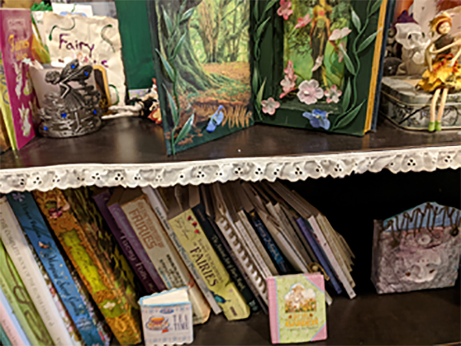 lace trimmed bookshelves with craft books