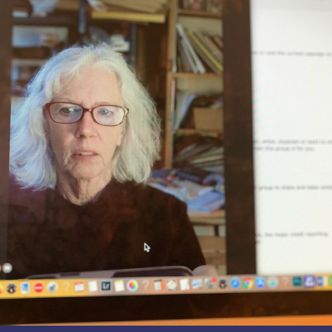 woman with white hair using computer for a zoom meeting