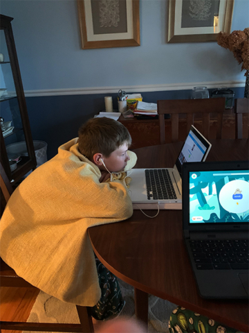 Young student peering at laptop computer