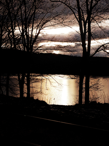 sunset over lake in dark tones