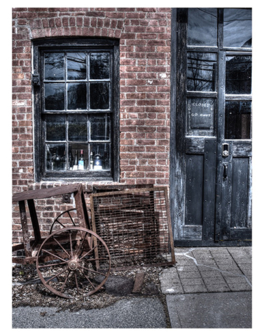 Old brick building black window frame and door sign closed go away