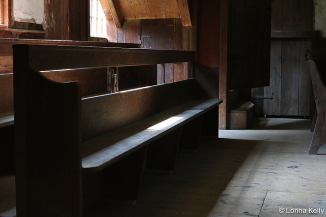 sunshine falling on wooden benches of quaker meeting house