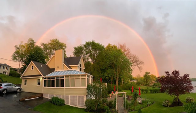 perfect arc of a rainbow over house