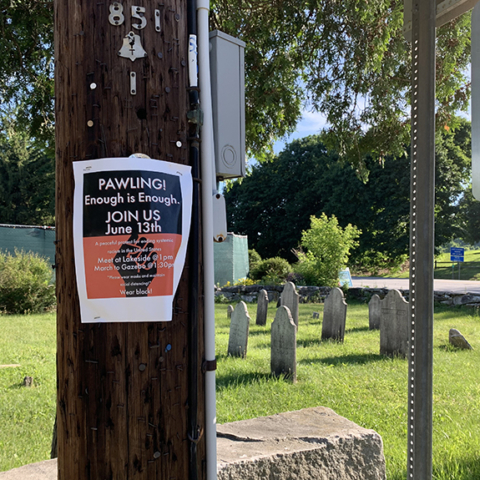flyer posted for = Pawling Enough is Enough rally on telephone poll graves in background