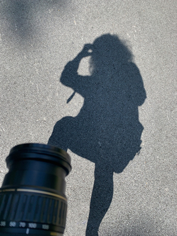 photographer lonna kelly camera lens and her shadow on pavement