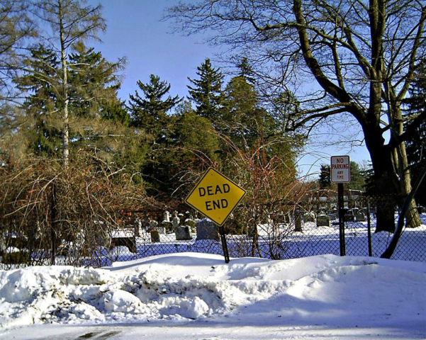 snow landscape dead end sign by cemetery