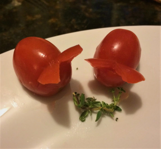 grape tomatoes cut to look like rabbits grazing on parsley